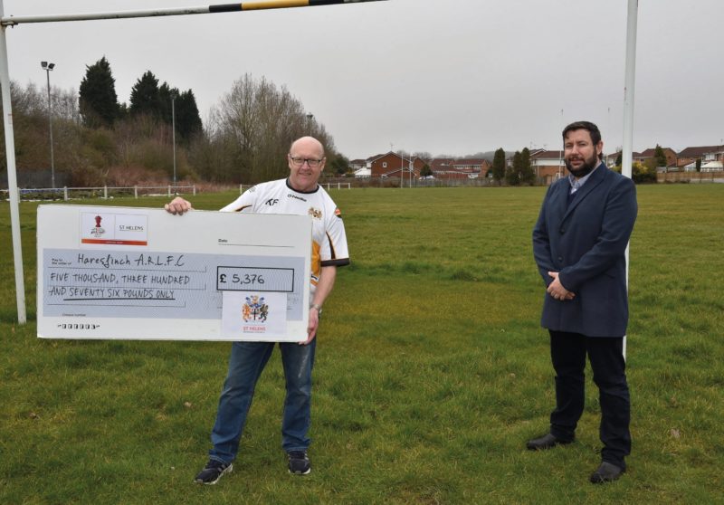 Cllr Anthony Burns presents the cheque for more than £5000 to Haresfinch ARLFC