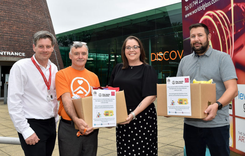 Cllr Jeanie Bell and Cllr Anthony Burns with Gordon Pennington from Our Warm Welcome outside St Helens Library at the World of Glass this week